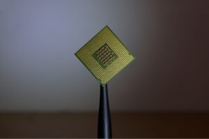 Image of a gold square computer chip on a dark background