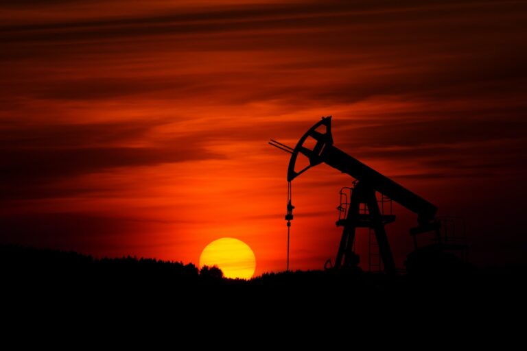 Image of an oil drill against a red sky